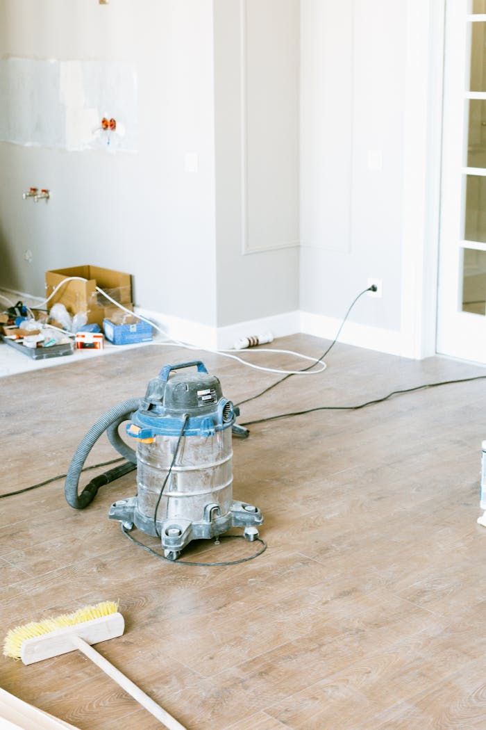 about-02 Vacuum and tools in a room undergoing renovation, showcasing home improvement.